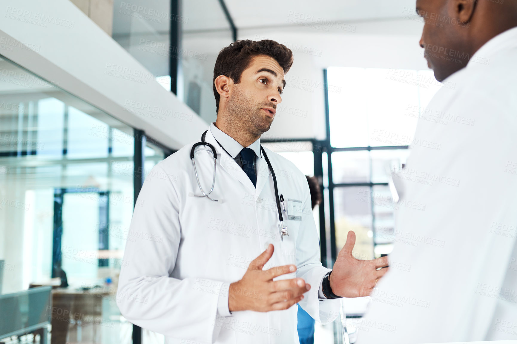 Buy stock photo Shot of two doctors having a discussion in a hospital