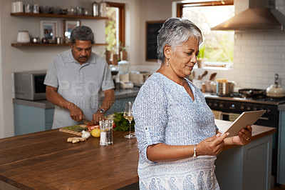 Buy stock photo Marriage, cooking and old couple in kitchen with tablet, healthy food and lunch time in home. Digital recipe, senior woman reading online and man making salad, nutrition and health in retirement diet