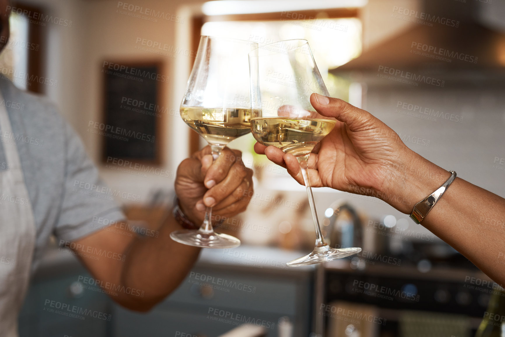 Buy stock photo Hands, couple and toast with wine in kitchen for celebration, anniversary or valentines day in home. People, partnership and commitment with trust, loyalty and drinks for cheers with love in house