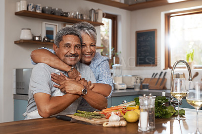 Buy stock photo Portrait of a happy mature couple cooking a meal together at home