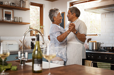 Buy stock photo Dancing, love and senior couple in kitchen for bonding, loving relationship and romance together in home. Retirement, marriage and mature man and woman with wine for cooking meal, lunch and dinner