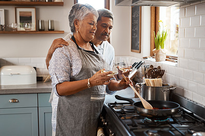 Buy stock photo Love, cooking pan and old man with happy woman at oven in kitchen, embrace and healthy marriage bonding in home. Happiness, help and food, senior couple with smile, frying and dinner in retirement.