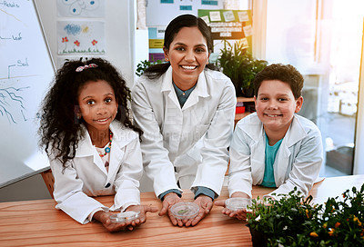 Buy stock photo Shot of an adorable little boy and girl learning about plants with their teacher at school