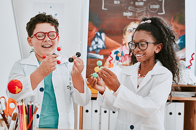 Buy stock photo Shot of two adorable young school children learning about molecules in science class at school