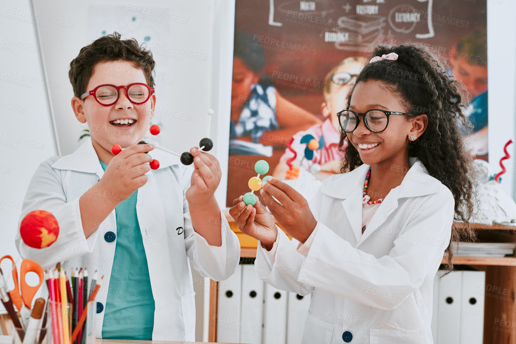 Buy stock photo Shot of two adorable young school children learning about molecules in science class at school