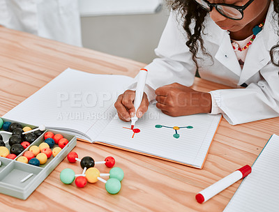 Buy stock photo Cropped shot of an adorable young school girl drawing a diagram in her exercise book in science class at school