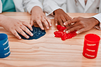 Buy stock photo Cropped shot of two unrecognizable school pupils playing and experimenting with slime in science class at school