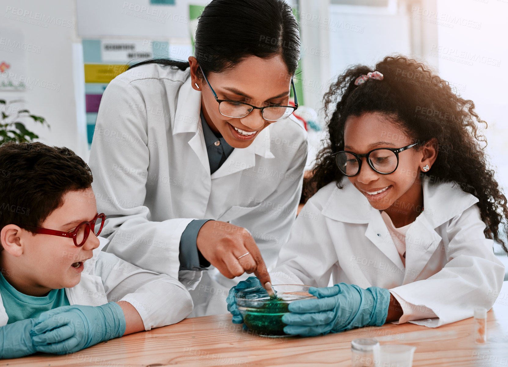 Buy stock photo Science, teacher and students in classroom with experiment, support and pride for learning. Chemistry, boy child and girl at school for research, solution and development or results for project