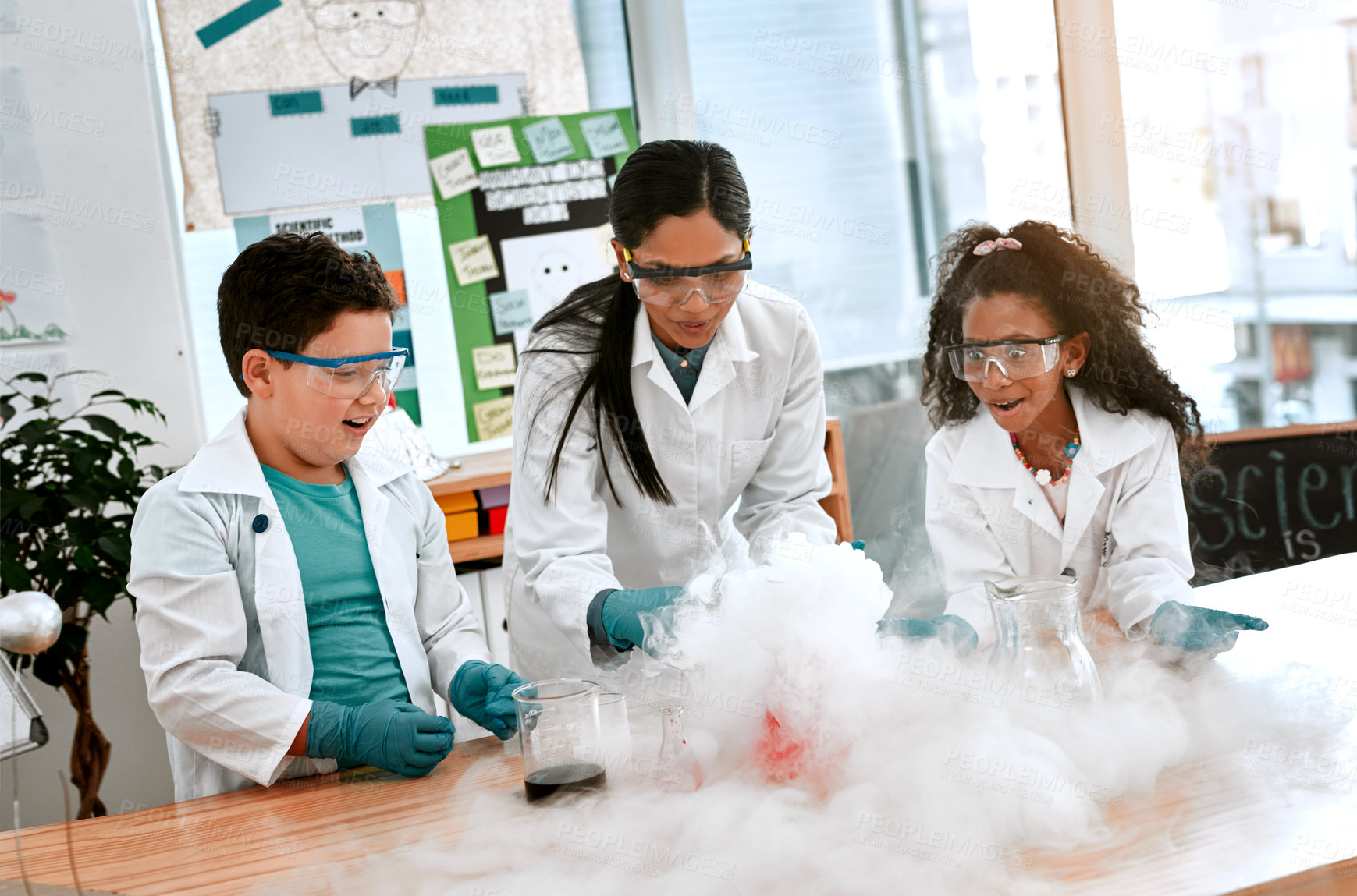 Buy stock photo Shot of an adorable little boy and girl conducting a scientific experiment with their teacher at school