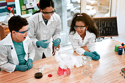 Buy stock photo Classroom, education or study with scientist and students at table in laboratory for reaction from above. Learning, school or science with woman teacher and children at academy for experiment