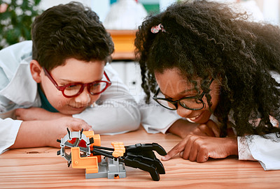 Buy stock photo Engineering, learning and children building a robot hand together in a classroom at school and being curious. Clever, education and young engineer students working in a science class doing research