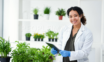 Buy stock photo Shot of a scientist using a digital tablet while standing in a lab