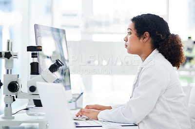 Buy stock photo Cropped shot of a female scientist using her computer while sitting in a lab