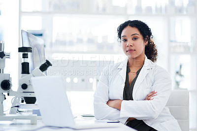 Buy stock photo Portrait of a female scientist sitting with her arms crossed at her desk