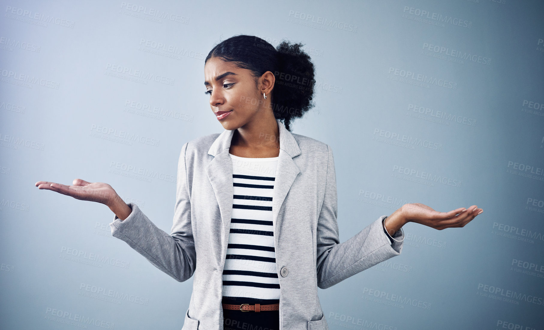 Buy stock photo Decisions, choices and options with a young business woman comparing and weighing up different decisions with copyspace in studio against a grey background. Picking between two balanced ideas
