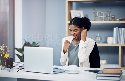 Buy stock photo Shot of a happy young businesswoman celebrating at her desk in a modern office