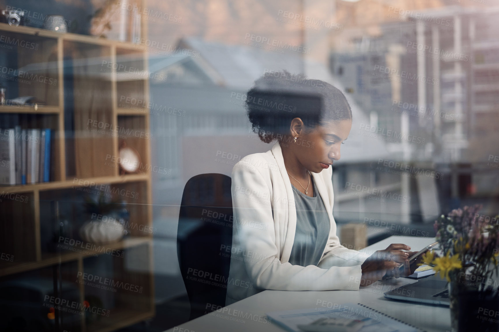 Buy stock photo Black woman, tablet and business analyst with window at desk in an office with analytics work. Internet, research and digital startup with a professional and tech with typing information for project