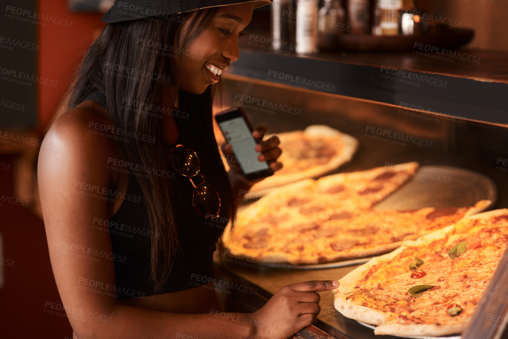 Buy stock photo Cropped shot of a young woman ordering pizza at a cafe