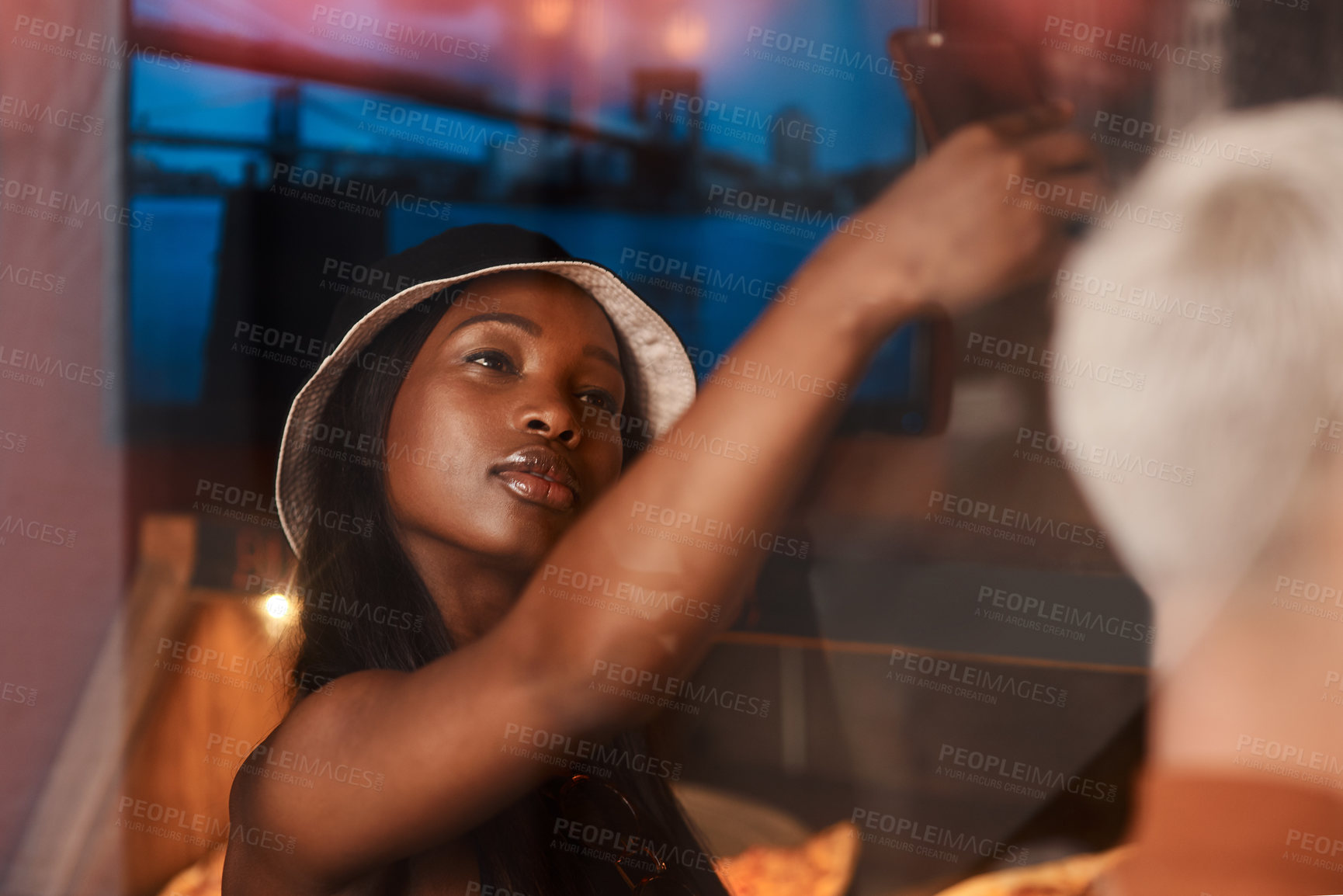 Buy stock photo African woman, selfie and cafe by window for vlog, live streaming and memory on website. Girl, influencer and person in night, virtual chat and video on mobile app on social network in restaurant