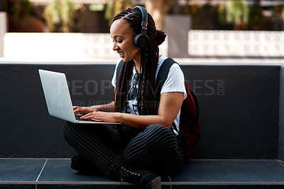 Buy stock photo Woman, student and headset or typing laptop, outside and online classes for elearning or education. University, learner and website research for assignment, listening and podcast or school project