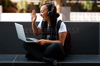 Buy stock photo Shot of an attractive young woman using her laptop to make a video call outdoors