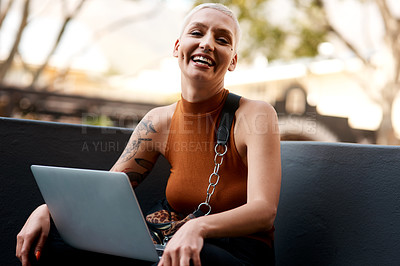 Buy stock photo Portrait of an attractive young woman using a laptop while relaxing outdoors