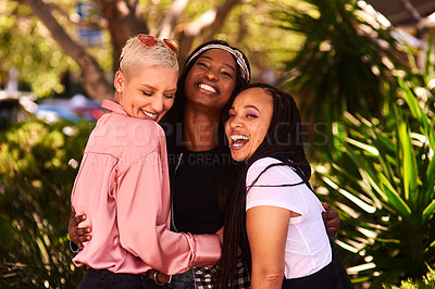Buy stock photo Shot of a group of three attractive young women having fun and enjoying themselves outdoors