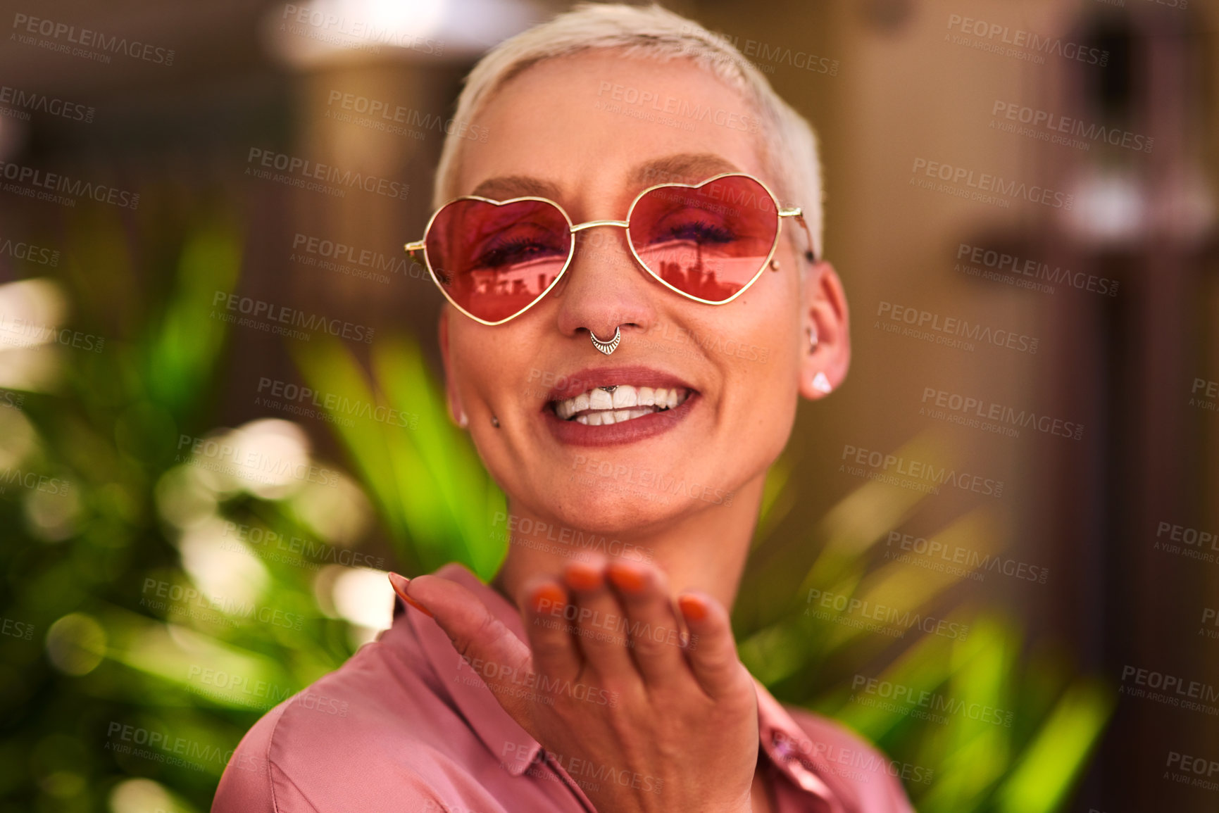 Buy stock photo Happy woman, portrait and blowing kiss with sunglasses for love, care or romance on valentines day in nature. Face of female person with jewelry, piercing or accessory for style or outdoor fashion