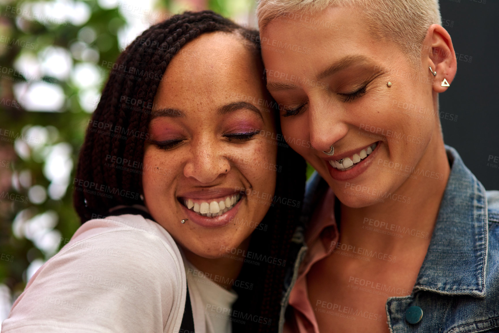 Buy stock photo Happy woman, lesbian and interracial couple with hug, love or care for embrace, LGBTQ or friendship in nature. Female person, friends or homosexual with smile for outdoor romance or relationship