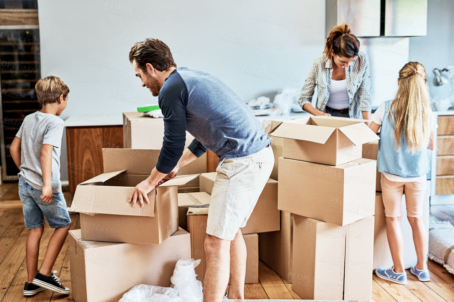 Buy stock photo Family, moving and children with boxes in new house for real estate, unpacking or property investment in living room. Parents, young kids and happy man with woman for relocation, helping or mortgage