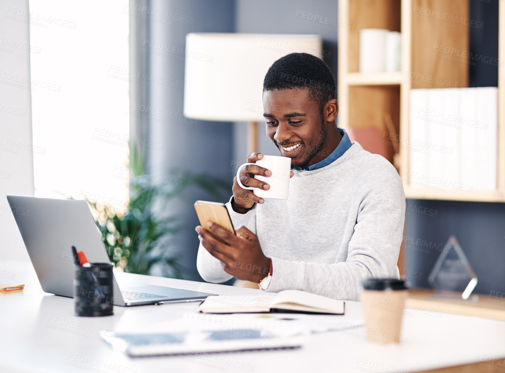 Buy stock photo Black man, smile and laptop in office with smartphone for web design, online project and social media. Business person, corporate and happy working on digital tech for research, planning and website