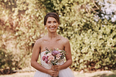 Buy stock photo Cropped portrait of a beautiful young bride smiling while standing with a bouquet in her hands on her wedding day
