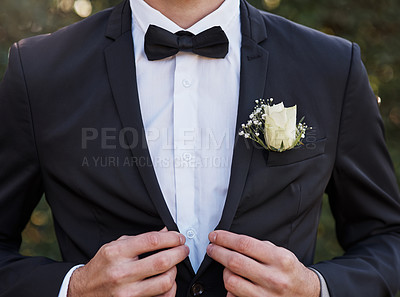 Buy stock photo Cropped shot of an unrecognizable bridegroom adjusting his suit while preparing for his wedding outdoors