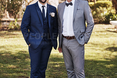Buy stock photo Cropped shot of an unrecognizable bridegroom standing outdoors with father on his wedding day