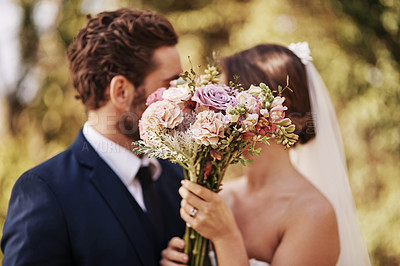 Buy stock photo Flowers, wedding and a married couple behind a bouquet together after a ceremony of tradition outdoor. Love, marriage or commitment with a man and woman outside as husband and wife in matrimony