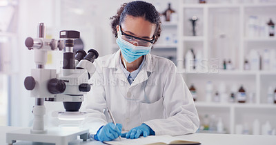 Buy stock photo Scientist face mask, woman writing and lab worker with medical research in a clinic. Data work, planning and working of a young female employee with a notebook and microscope results for science
