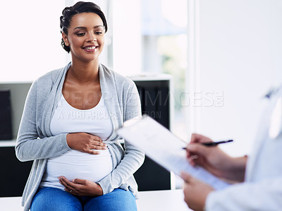 Buy stock photo Cropped shot of an unrecognizable female doctor consulting with a pregnant patient at a hospital during the day