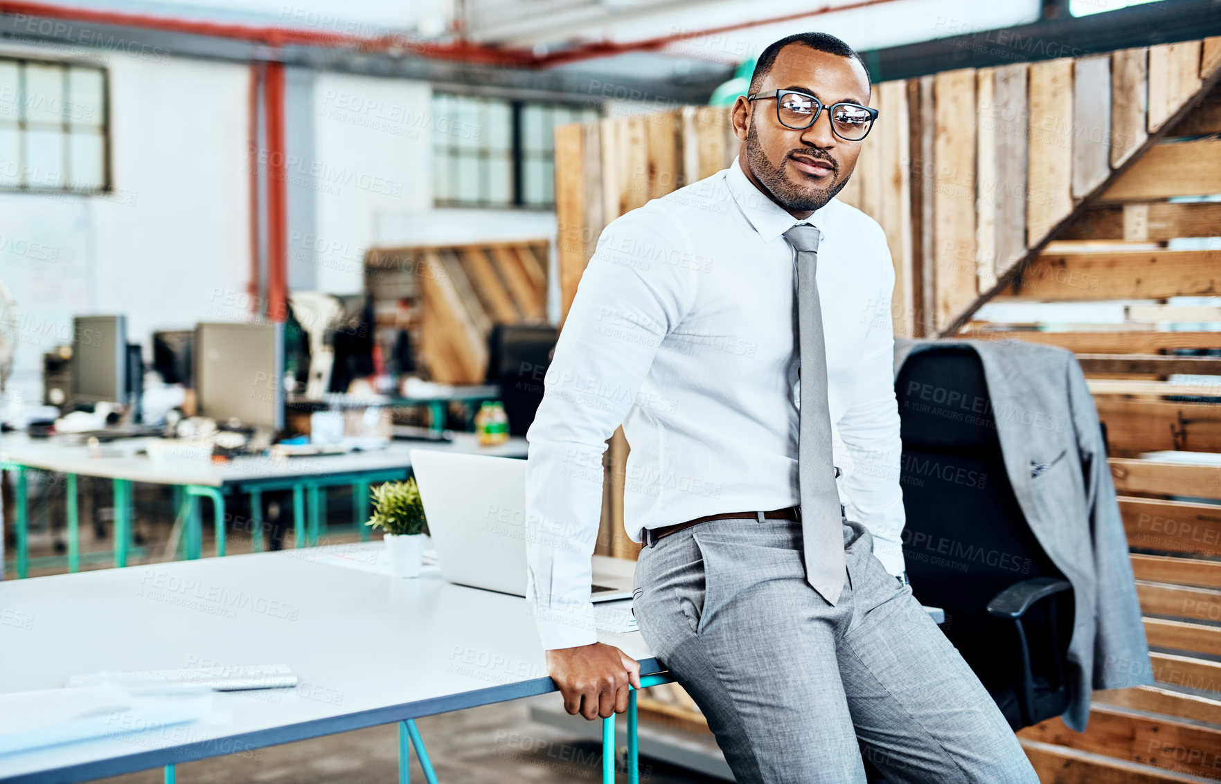 Buy stock photo Portrait, laptop and man in office, serious and confident on desk, ideas and professional with glasses. Business, black person and lawyer of system, constitution and public defender in Botswana