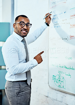 Buy stock photo Cropped portrait of a handsome young businessman standing alone in his office and writing on a white board