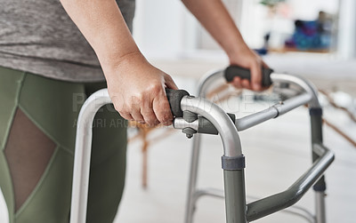 Buy stock photo Cropped shot of an unrecognizable mature woman using a walker to walk during a her physiotherapy session at a clinic