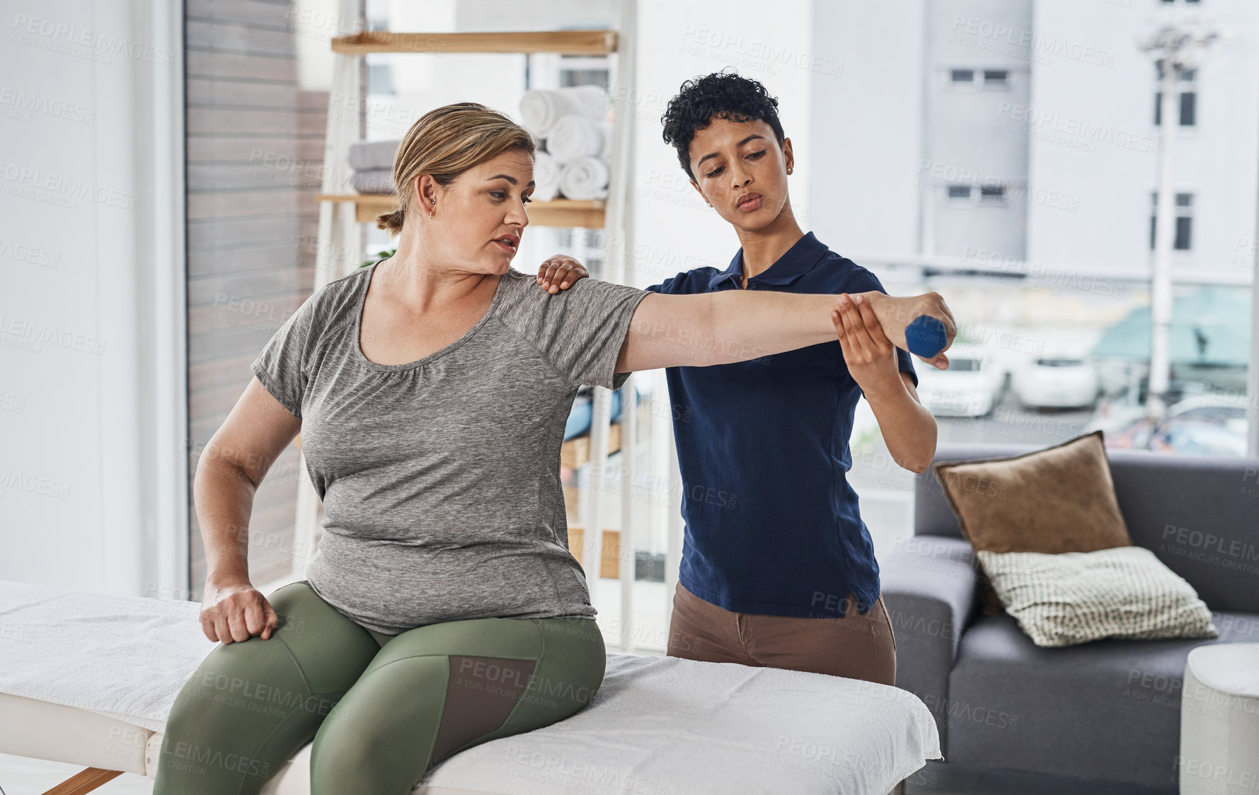 Buy stock photo Physiotherapy, woman arm and medical consultant with healthcare and rehab advice. Weight, consultation and conversation for injury care and discuss exercise for joint help, healing and health