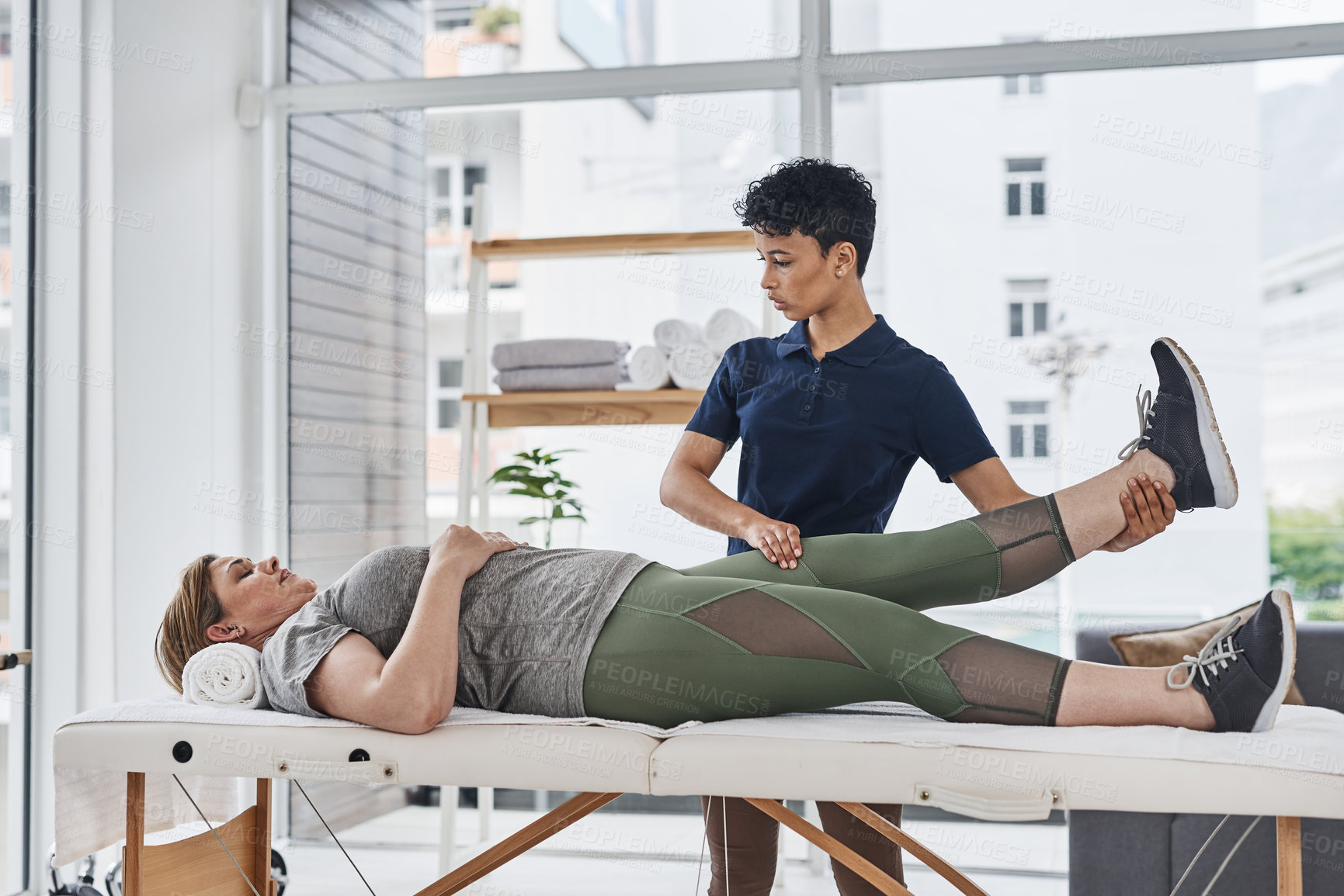 Buy stock photo Physiotherapist, woman and leg exercise for health, wellness and help in gym, clinic or session. Female people, trainer and patient in physiotherapy, fitness or strong muscle at rehabilitation center