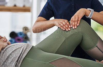 Buy stock photo Shot of an unrecognizable woman getting her knee examined by a physiotherapist at a clinic
