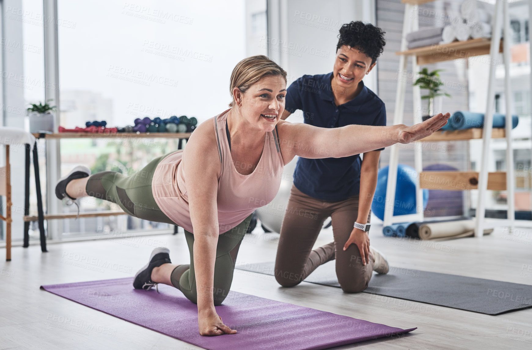 Buy stock photo Full length shot of a mature woman doing balance and movement exercises with her physiotherapist at a rehabilitation centre