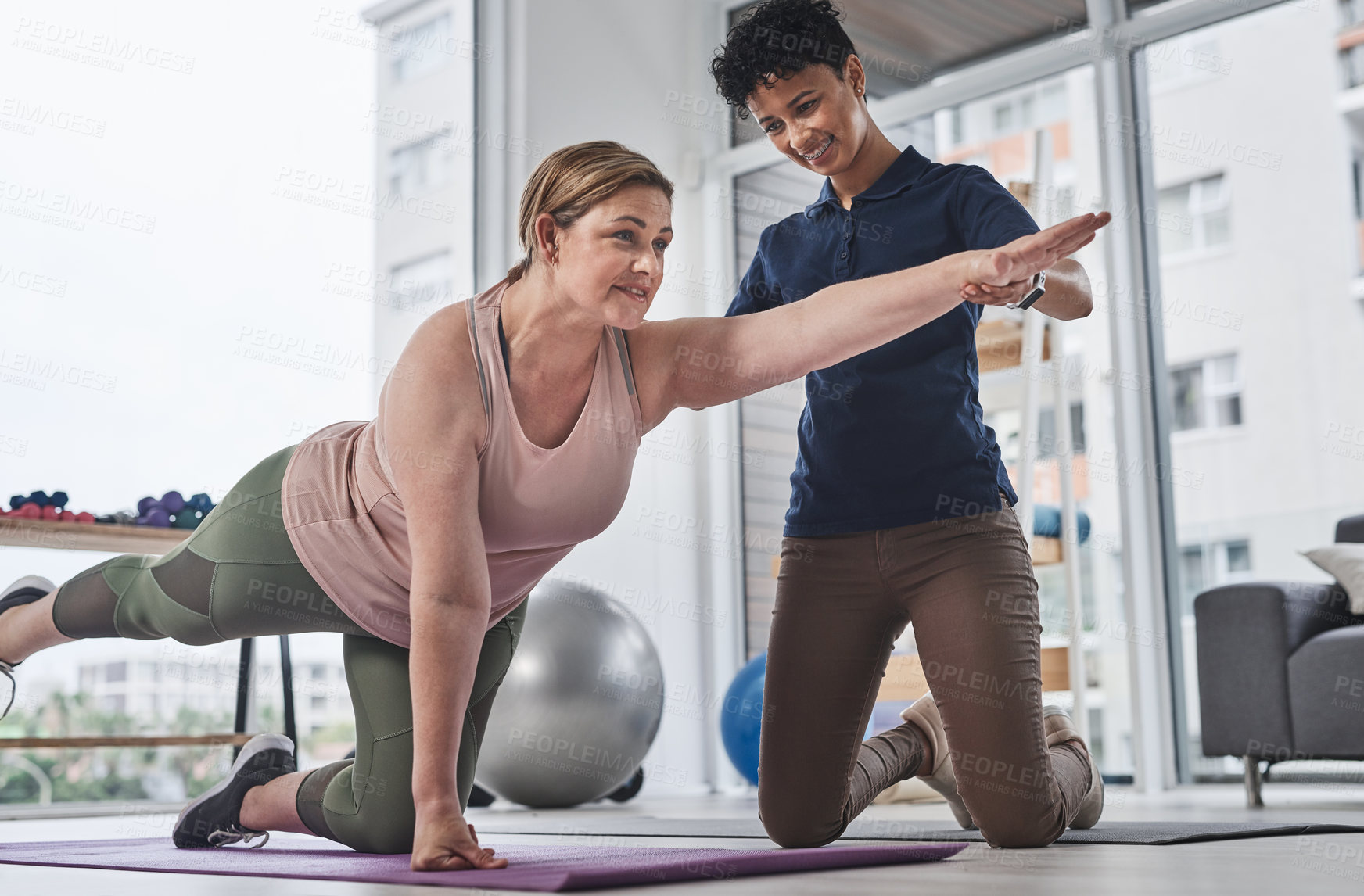 Buy stock photo Physiotherapy, woman and stretching for exercise, wellness and balance in rehabilitation clinic. Female people, trainer and patient with physiotherapist, fitness and muscle recovery in health center