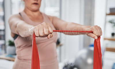 Buy stock photo Cropped shot of an unrecognizable woman exercising with a resistance band during her physiotherapy session at a clinic