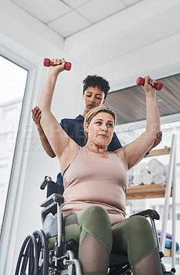 Buy stock photo Physiotherapist, woman and wheelchair for exercise, health or help in gym or wellness clinic. Female people, trainer and patient with weightlifting, fitness and strong muscle in rehabilitation center