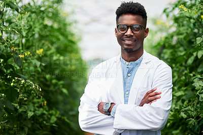 Buy stock photo Portrait of a handsome young botanist posing with his arms folded outdoors in nature