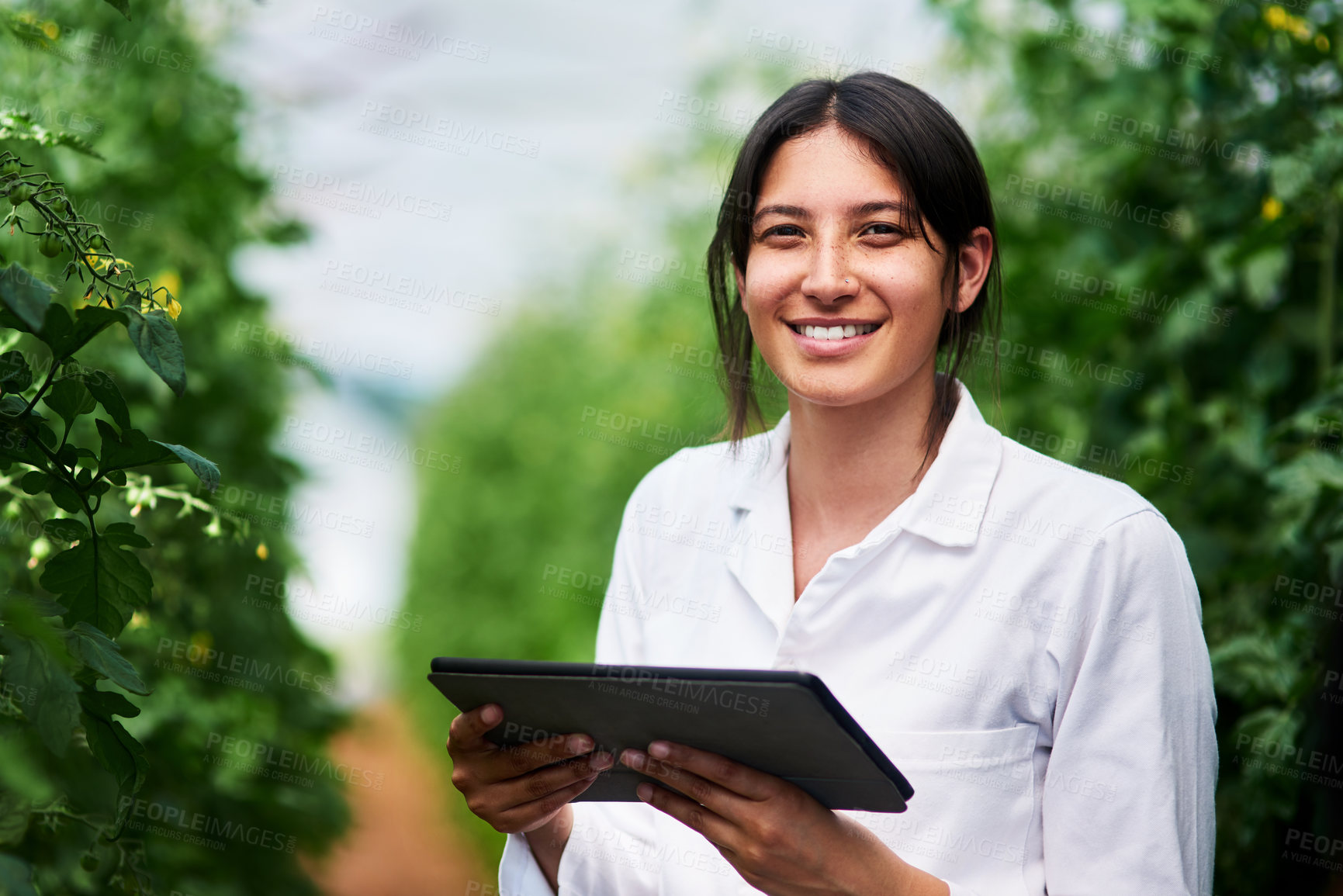 Buy stock photo Portrait of an attractive young botanist using a digital tablet while working outdoors in nature