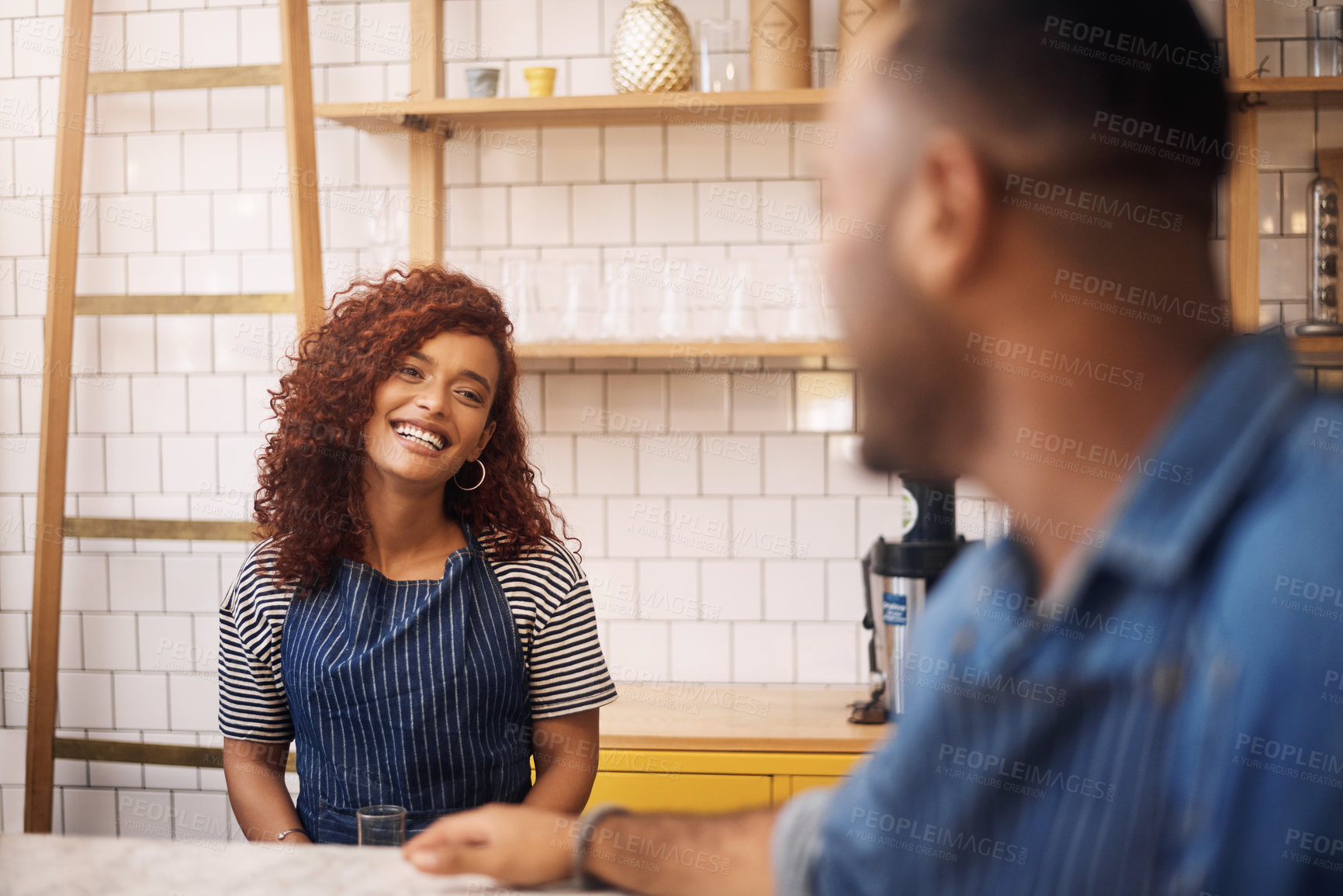 Buy stock photo Cropped shot of an attractive young businesswoman standing and assisting a customer in her cafe